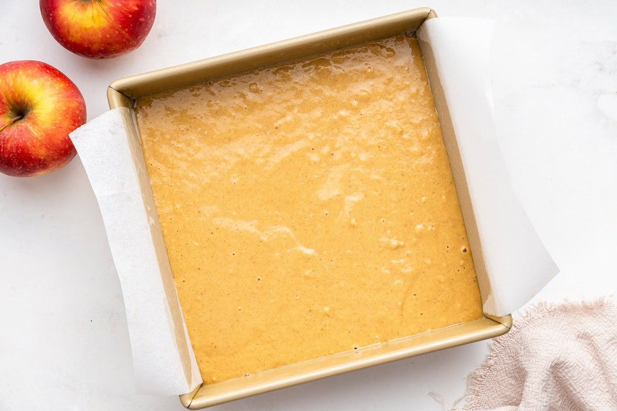 Applesauce cake batter in a square baking dish.