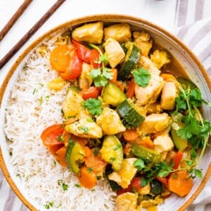 Chicken curry with vegetables served with rice.