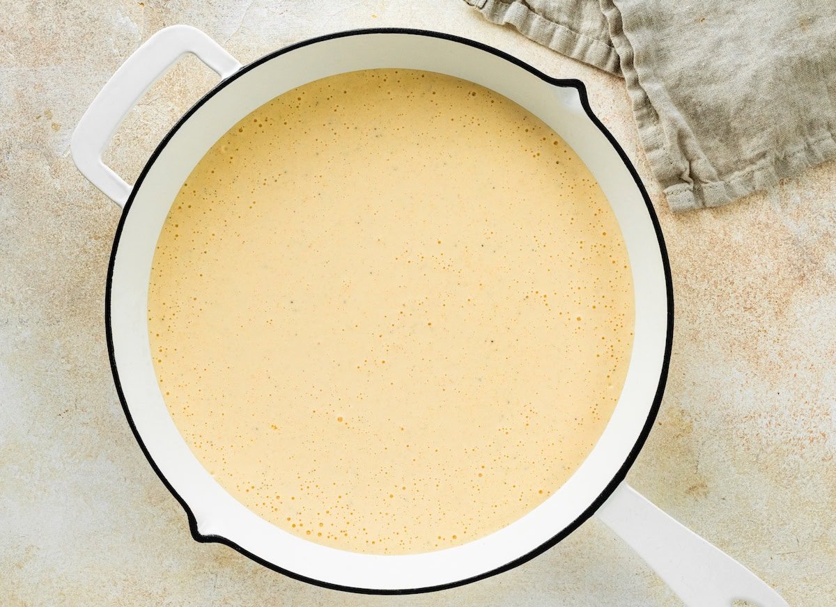 A cottage cheese sauce in a pan used for mac and cheese.