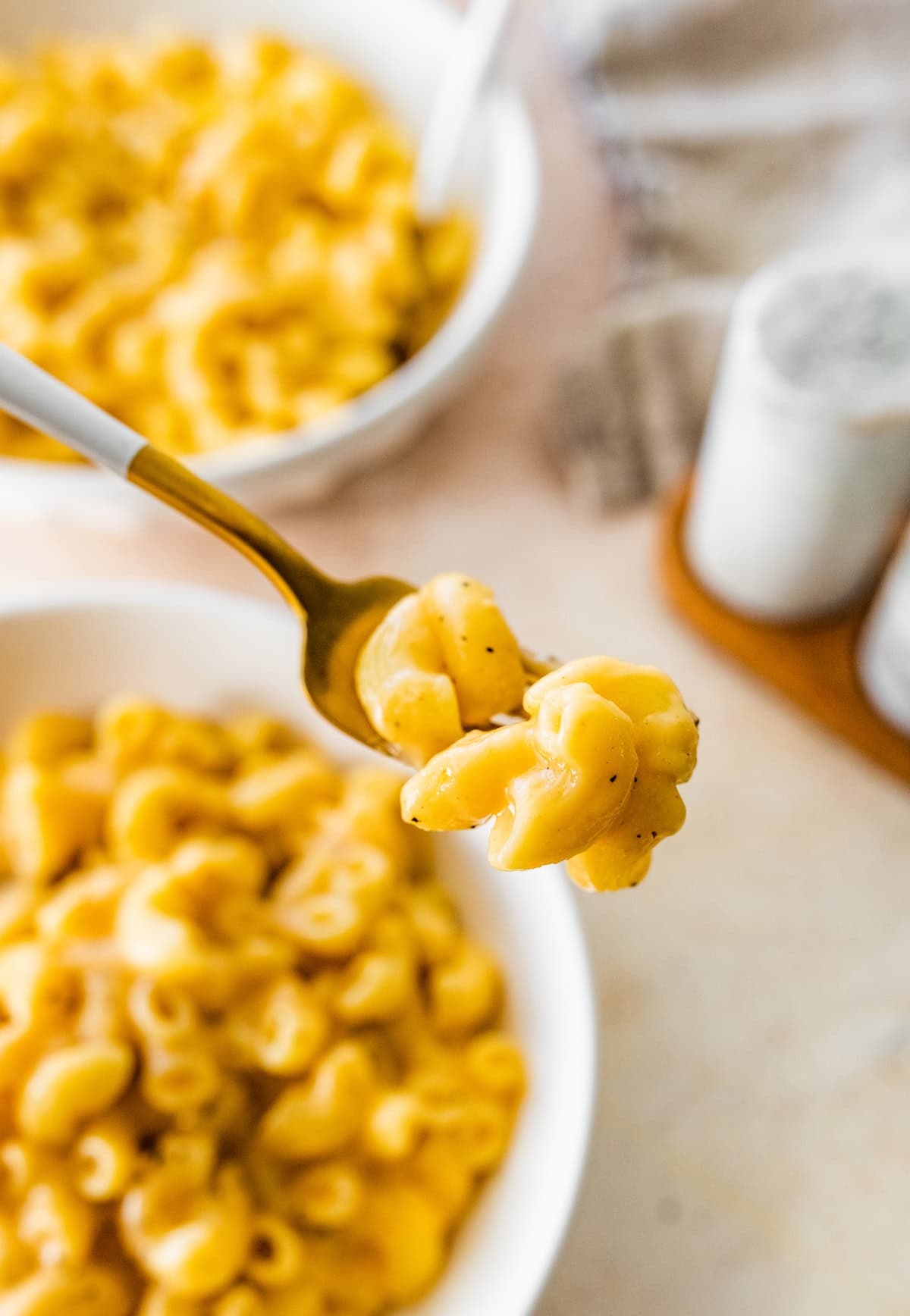 A bite size serving of cottage cheese mac and cheese on a fork.