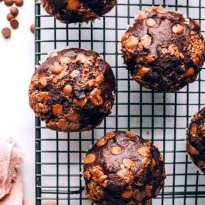 A birds eye view of 4 chocolate chip muffins on a wire rack.