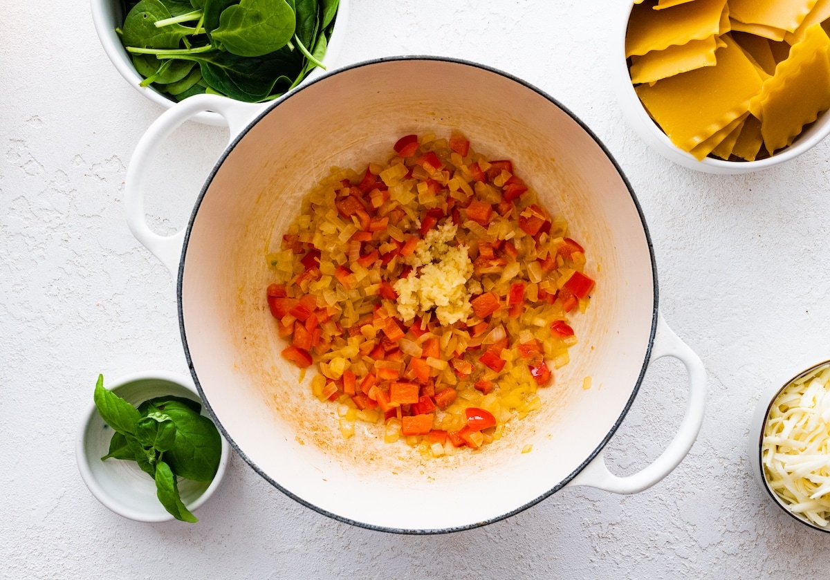 Sauteed onions, bell peppers, and garlic in a large pot.