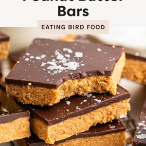 Three Healthy Peanut Butter Bars, topped with salt. One has a bite taken out of it.