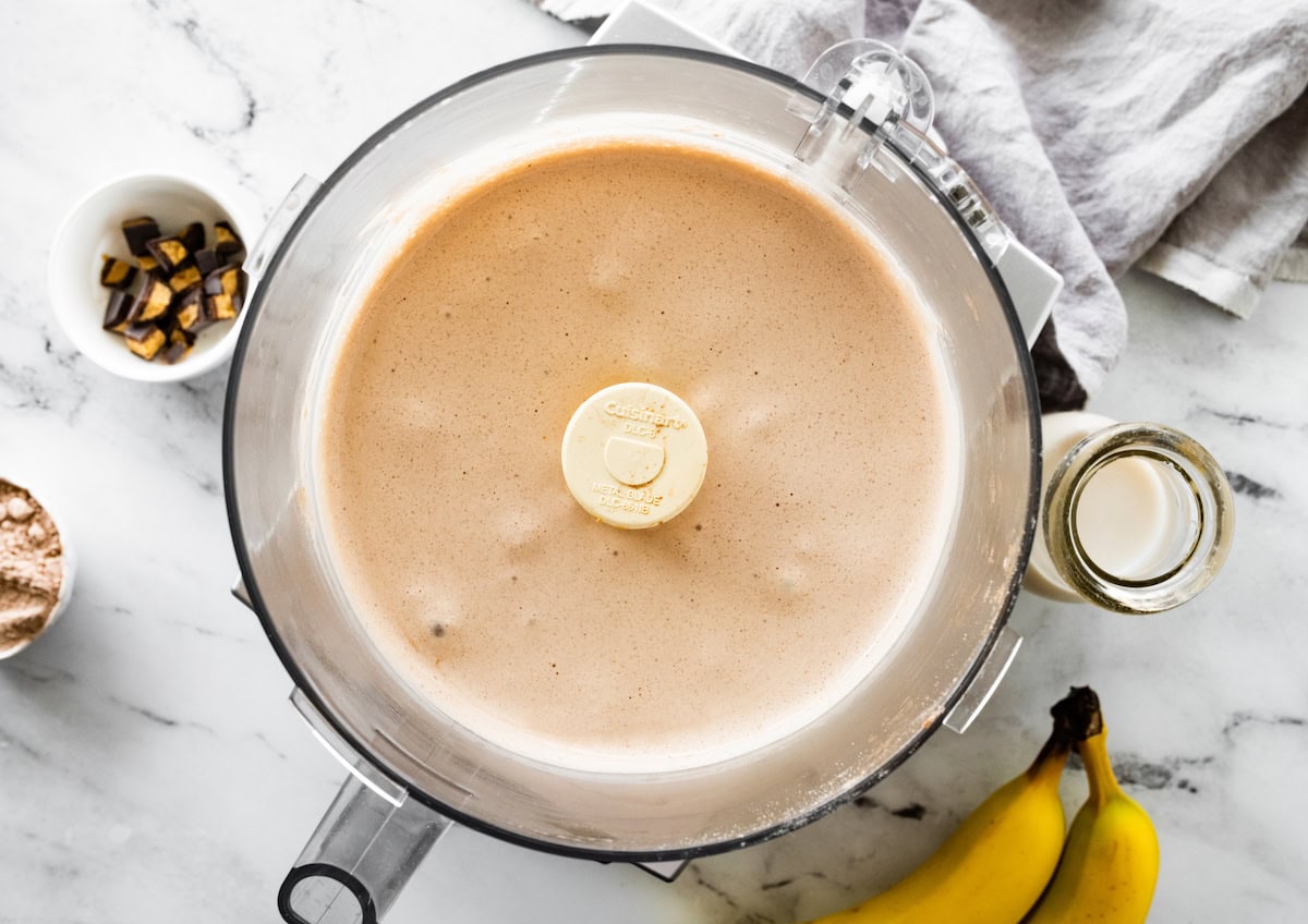 A food processor of blended peanut butter cup protein fluff.