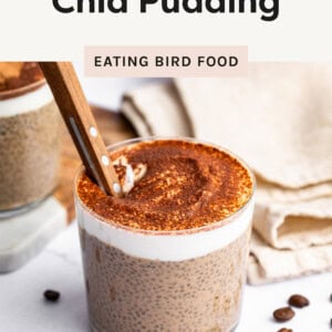 Photo of Tiramisu Chia Pudding in a glass jar with a spoon in the glass.
