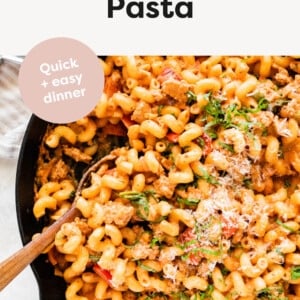Ground Turkey Pasta in a skillet with a wooden spoon.